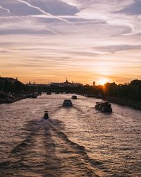 Scenic view of river against sky during sunset
