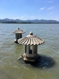Lifeguard hut on sea against sky