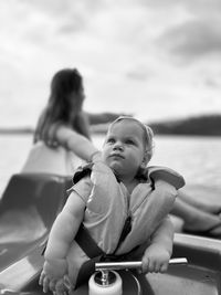 Side view of mother and daughter in boat