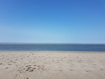 Scenic view of sea against clear blue sky