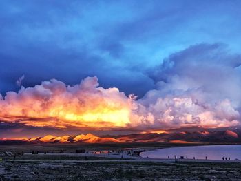 Scenic view of sea against dramatic sky during sunset