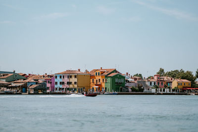 Houses and buildings in town against sky