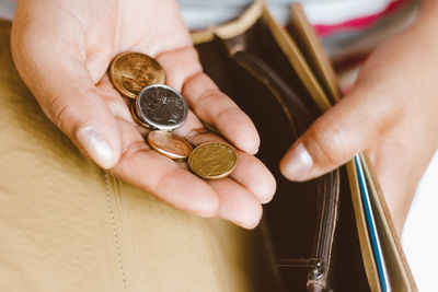 Close-up of hand holding coins