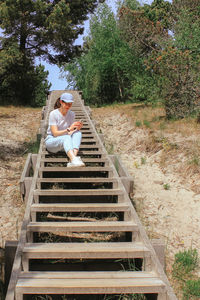 A girl on a trip uses a technical device to post photos or videos on social networks. summer walk