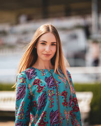 Portrait of smiling young woman standing outdoors