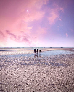 People on beach against sky