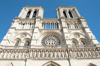 Low angle view of notre dame against blue sky