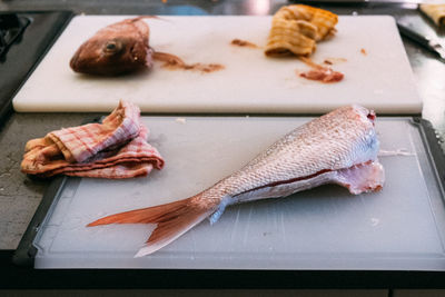High angle view of dead fish on cutting board