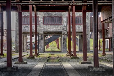 Metal columns against old building at zollverein coal mine industrial complex