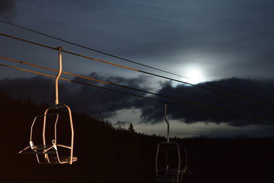 Ski lift against sky during sunset