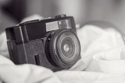 Close-up of camera on bed