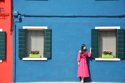 Woman standing by window