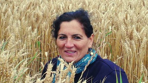 Portrait of smiling young woman standing in field