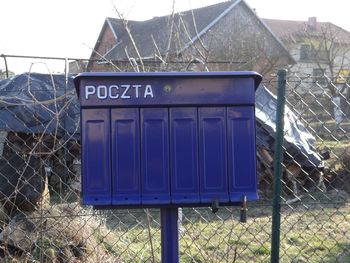 Information sign on fence by building