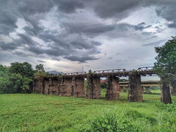 Scenic view of storm clouds over grass