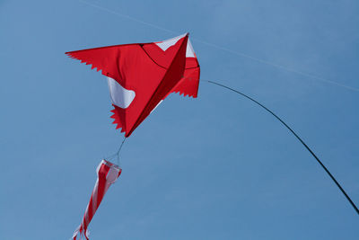 Low angle view of kite flying against clear sky