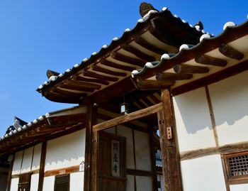 Low angle view of roof of building against clear sky