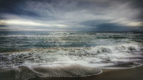 Scenic view of sea against cloudy sky