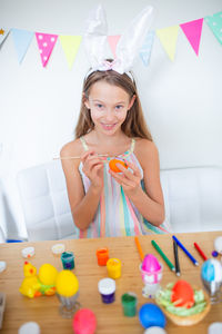 Portrait of happy girl on table