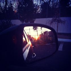 Sunset reflecting in side-view mirror