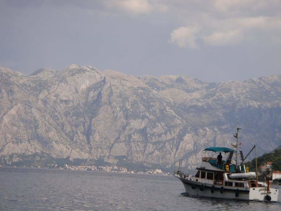 nautical vessel, transportation, mode of transport, water, mountain, boat, waterfront, sea, sky, scenics, mountain range, sailing, beauty in nature, travel, nature, tranquility, tranquil scene, moored, cloud - sky, sailboat