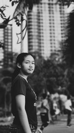 Portrait of young woman standing outdoors
