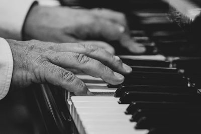 Midsection of man playing piano