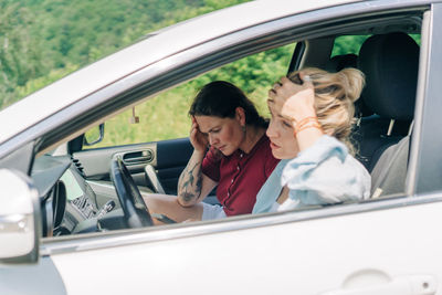 Portrait of young woman in car