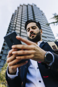 Portrait of young man using mobile phone