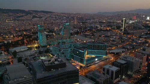 Aerial view of illuminated city buildings at night