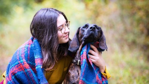 Close-up of young woman with dog