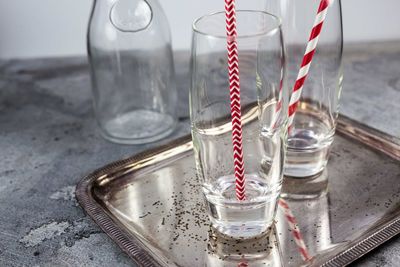 Close-up of straws in glasses