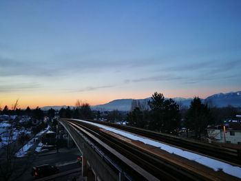 High angle view of railroad tracks against sky at night