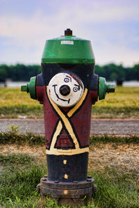 Close-up of fire hydrant on field against sky
