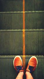 Low section of person standing on tiled floor