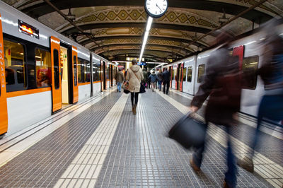 People waiting at railroad station platform