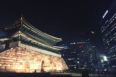 Low angle view of illuminated building at night