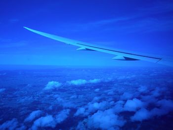 Airplane wing against blue sky