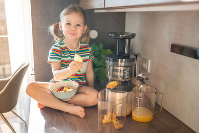 Portrait of cute girl standing in kitchen