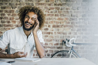 Happy young man at desk