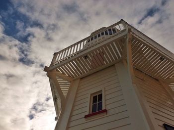 Low angle view of building against cloudy sky