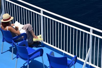 Man sitting on chair by sea