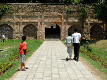 Rear view of women walking at temple