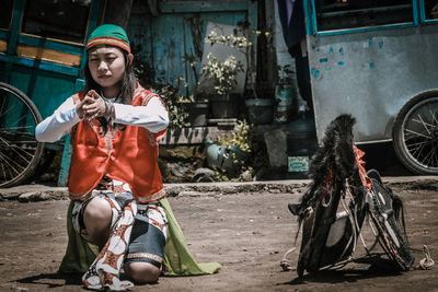 Young woman sitting outdoors