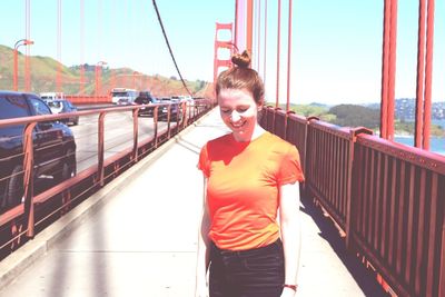 Portrait of woman on bridge against sky