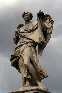 Low angle view of statue, angelo, ponte sant'angelo, roma