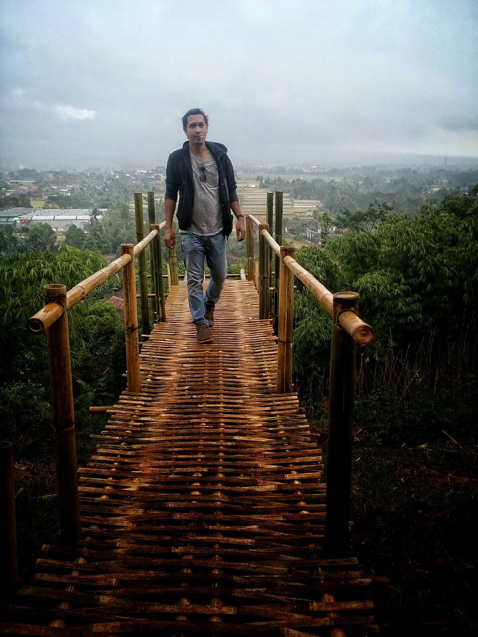 full length, one person, railing, sky, outdoors, cloud - sky, people, adults only, front view, leisure activity, steps, one man only, nature, day, adult, sports training, only men, wood paneling