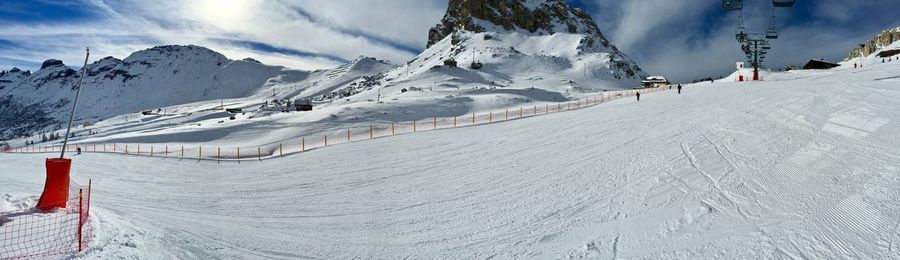 Scenic view of snow covered mountains against sky