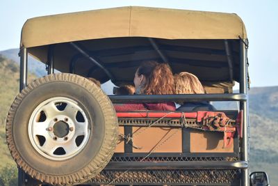 Rear view of people in land vehicle