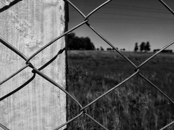 Close-up of chainlink fence against sky